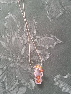 Silver tone necklace with sandal pendant